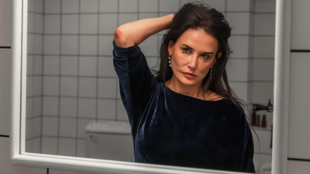 Demi Moore looking in the mirror in a scene from The Substance (Mubi)