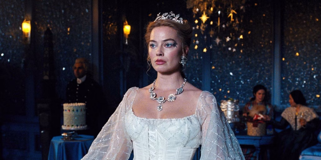 Margot Robbie as Catherine Earnshaw wearing a white gown and jeweled tiara at a formal indoor event in Wuthering Heights (2026).