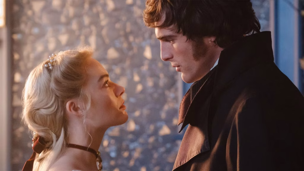 Cathy and Heathcliff stand face to face indoors in period costume, staring intensely at each other in a close-up scene.