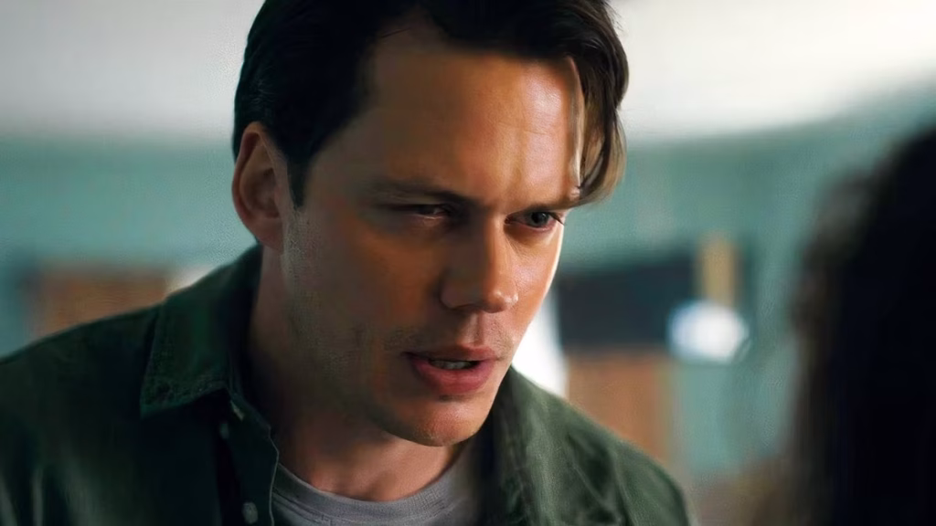 Bill Skarsgård leans forward as Keith in a close-up scene from Barbarian.