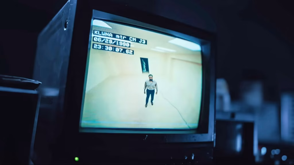 Monitor showing a man standing alone inside a yellow Backrooms-style room.