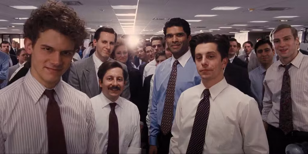 Stratton Oakmont brokers standing together in an office in The Wolf of Wall Street.