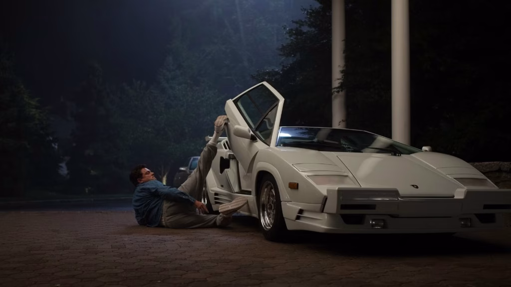 Jordan Belfort lying beside a white Lamborghini in The Wolf of Wall Street.