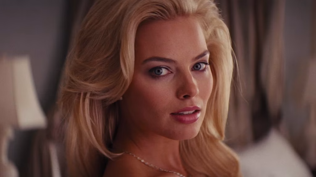 Margot Robbie as Naomi Belfort looking toward the camera in The Wolf of Wall Street.